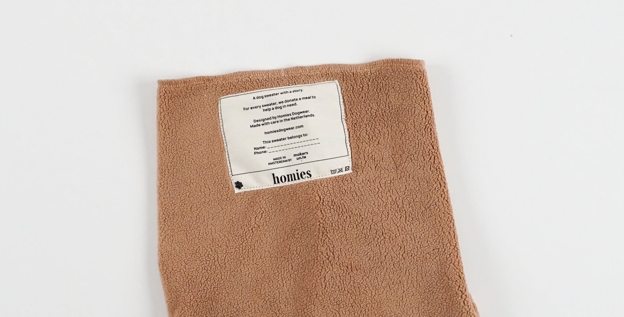 Camel dog fleece sweater with a label on a white background